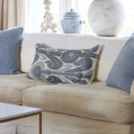 cream sofa with blue patterned pillows