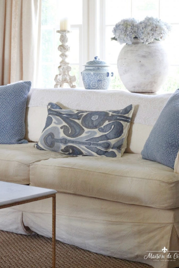 blue pillows on cream sofa