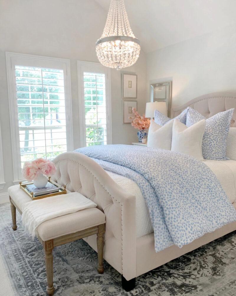 beautiful blue patterned comforter and white headboard to decorate a bedroom with pink flowers