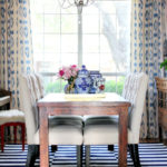dining room with blue drapes and rug