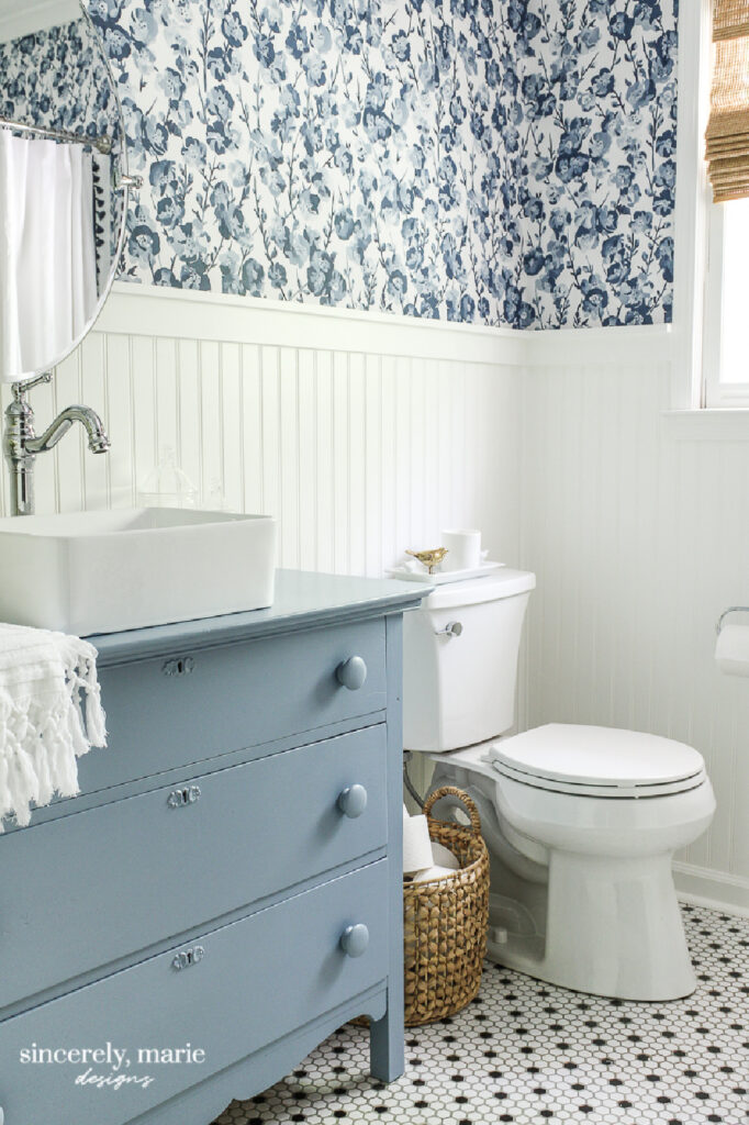  floral blue wallpaper in bathroom with pale blue vanity