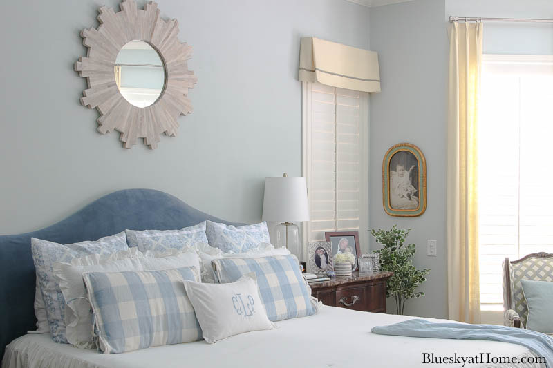 blue and white bedroom with blue headboard and white comforter, blue and white bed pillows