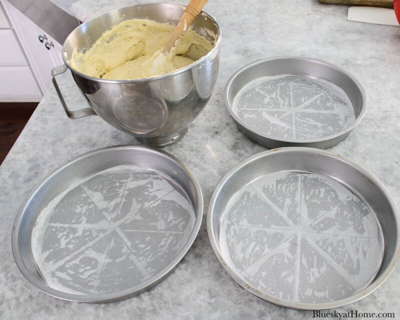 3 cake pans buttered with parchment paper