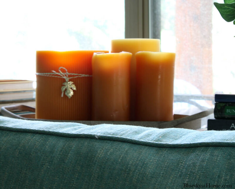 orange candles on sofa table