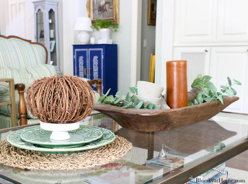 fall coffee table vignettes with orange candle and pumpkin