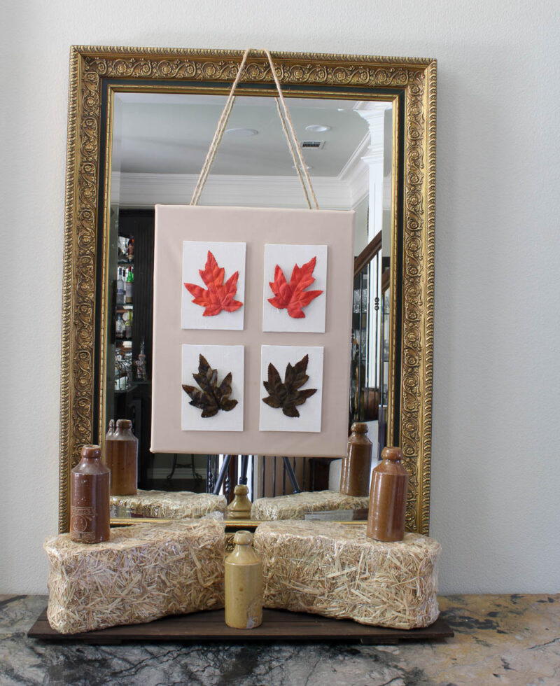 4 fall leaf canvases on large canvas hanging on mirror