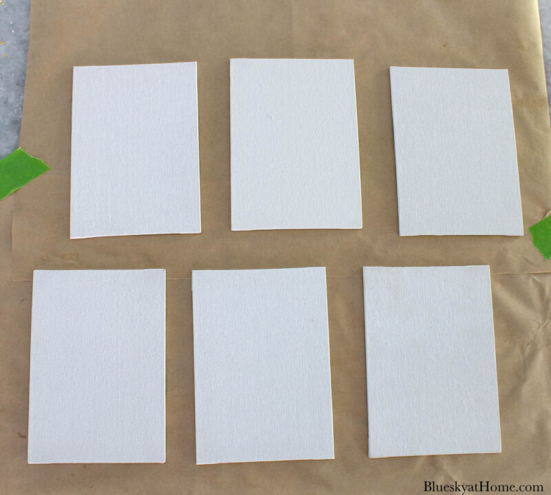 6 small white canvases