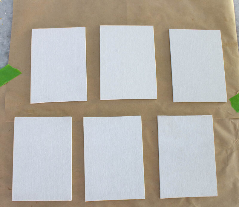 6 small white canvases
