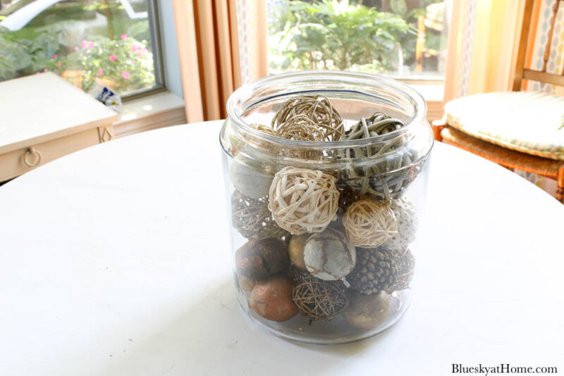 glass jar with fall colored balls