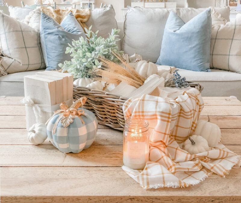 flal coffee table with blue check pumpkin and pale orange throw