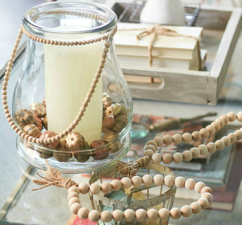 glass jar with candle and beads