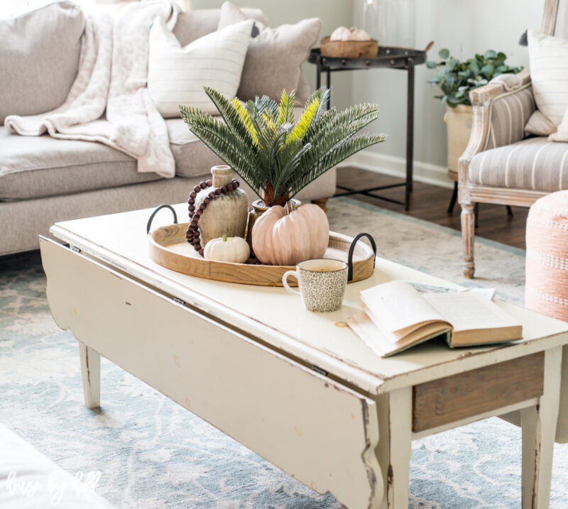 rustic white coffee table with early fall decorative accessories