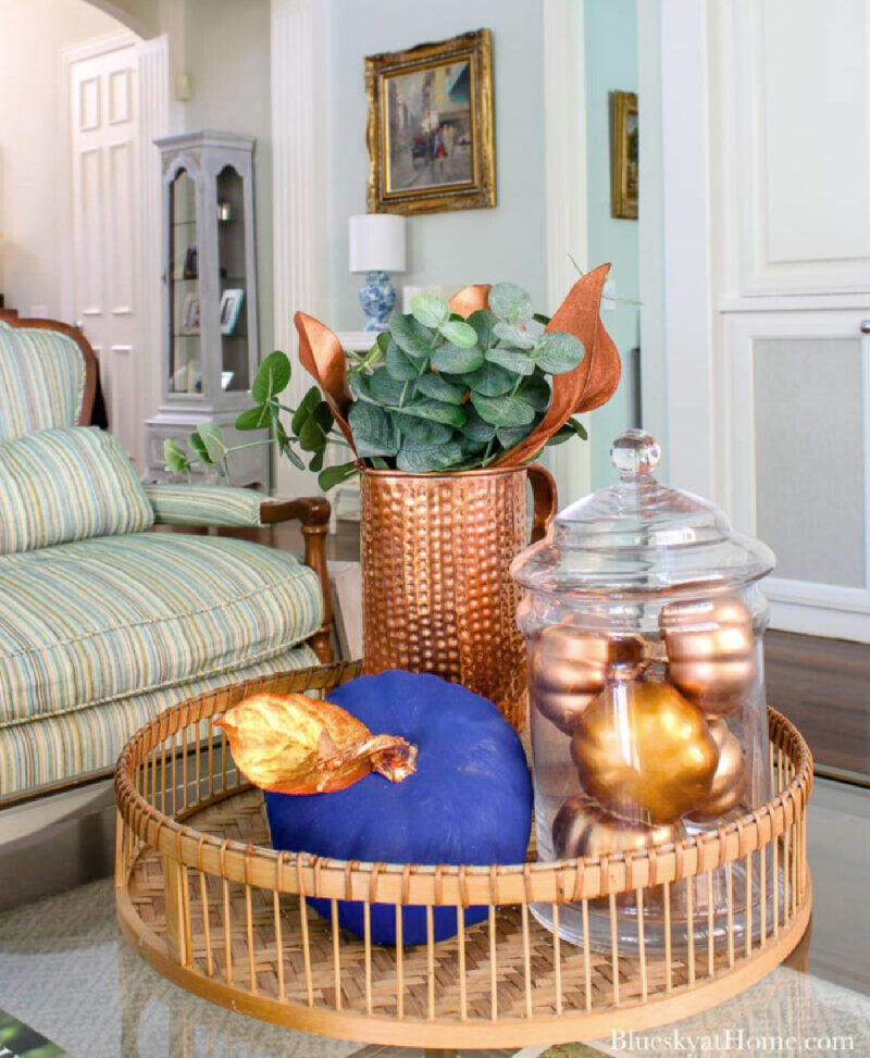 fall living room accessories with copper pitcher and blue pumpkin and gold pumpkins