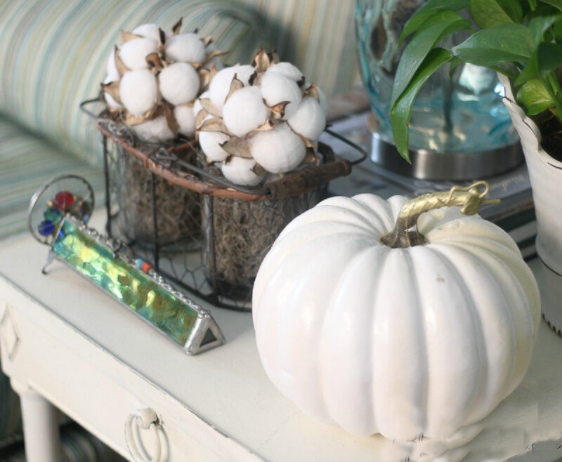 white pumpkin with cotton bolls in wired basket