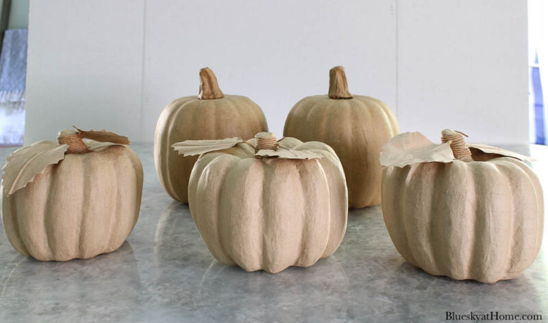 five paper maché pumpkins