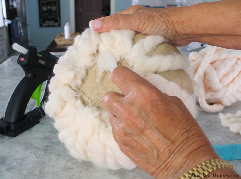 glueing yarn to pumpkin