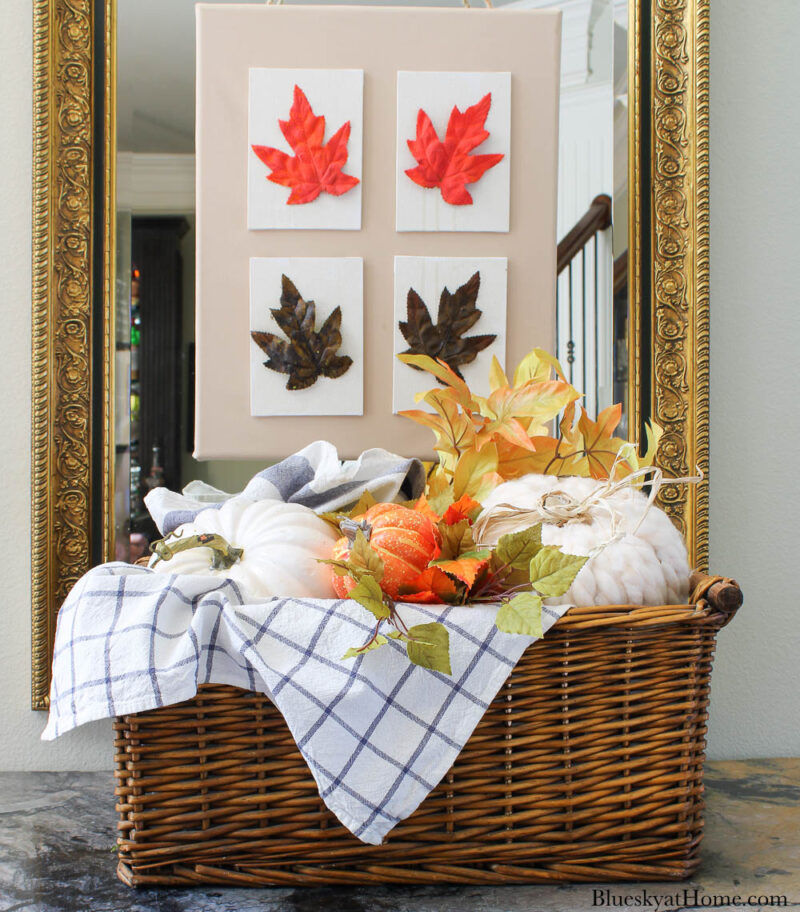 decorative pumpkin with yarn in basket and blue check dishtowels