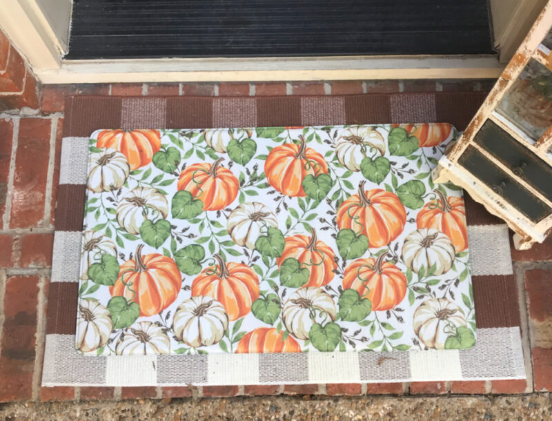 pumpkin mat on brown and white check mat