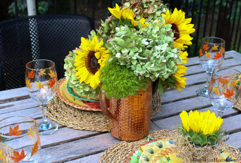 sunflowers and hydrangeas in copper pitcher