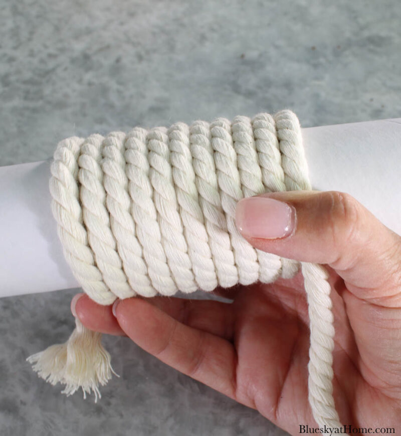 wrapping white rope around white tube