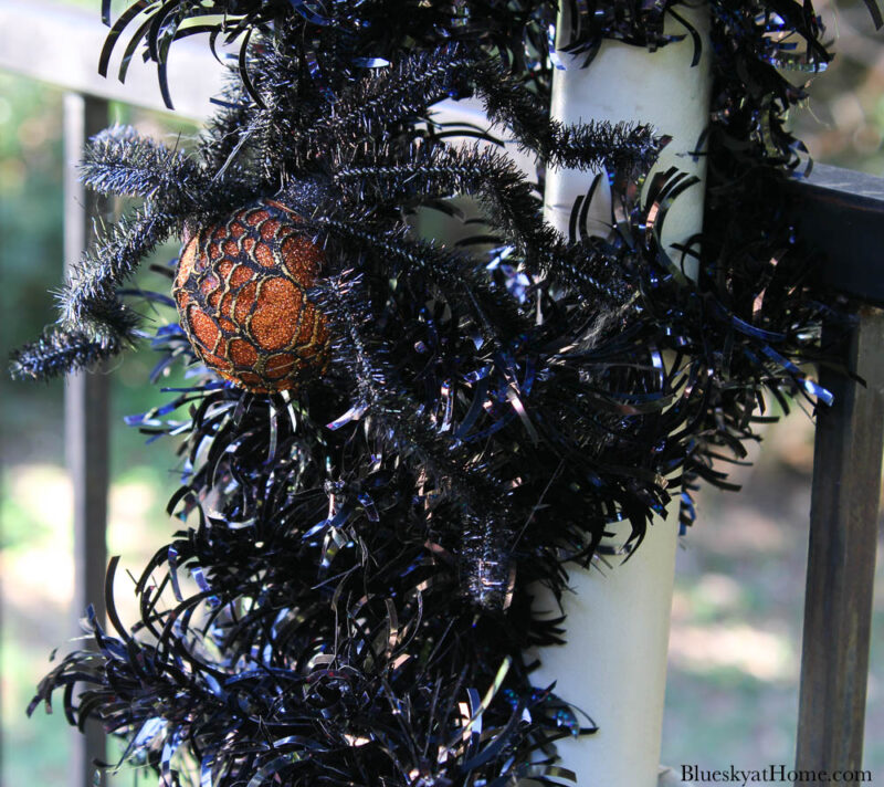 black garland on post with spider