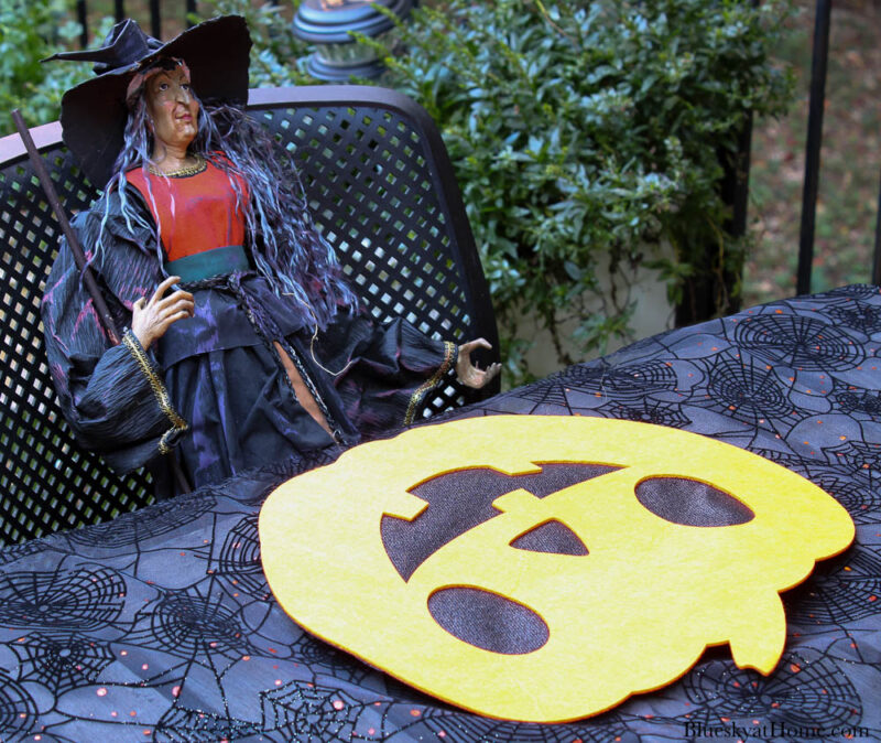 Halloween tablescape on the patio place setting with pumpkin placemat