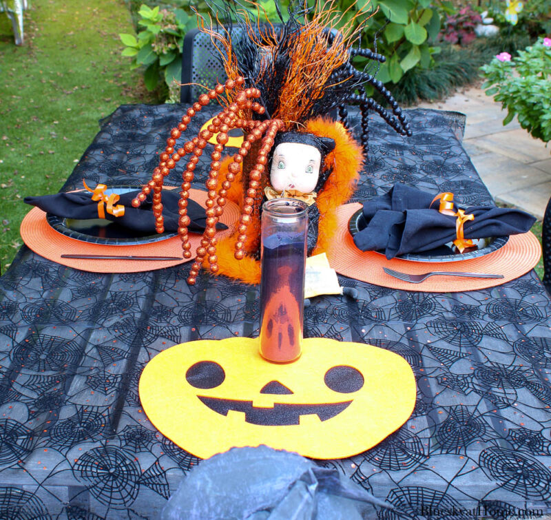 Halloween tablescape on the patio place setting with pumpkin placemat