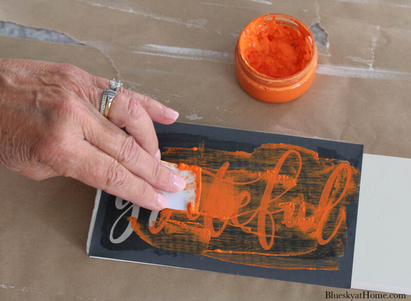 painting stenciling Thanksgiving sayings on wood slats