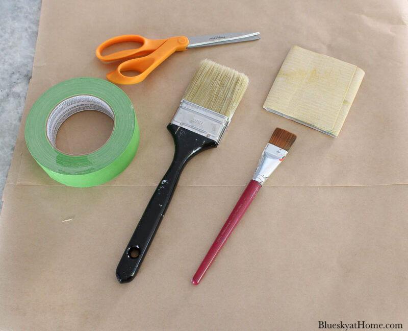 scissors, paint brushes, painters tape, sand paper