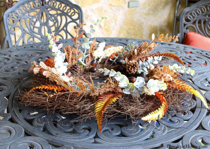 round grapevine wreath with leaves on table