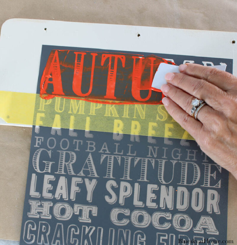 stenciling wood sign with orange paint