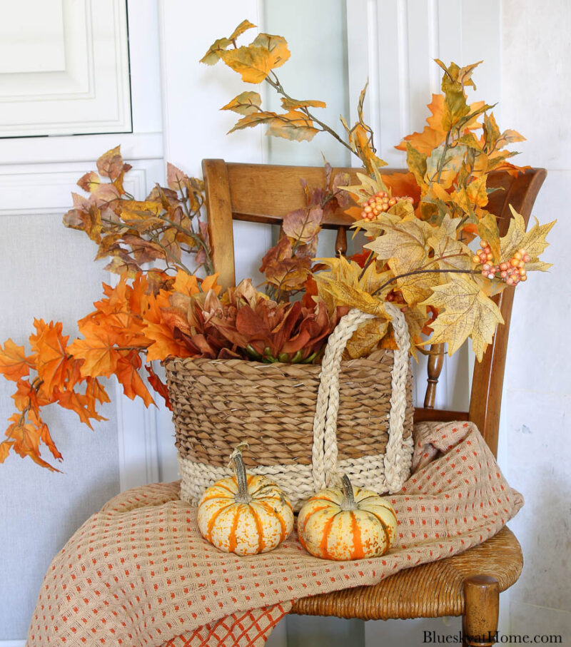 basket of fall foliage on chair