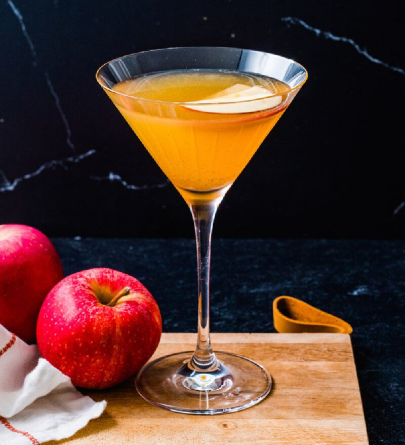 apple cider martini and apples on cutting board