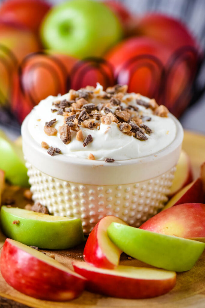 bowl of apple dipping sauce with apples in background