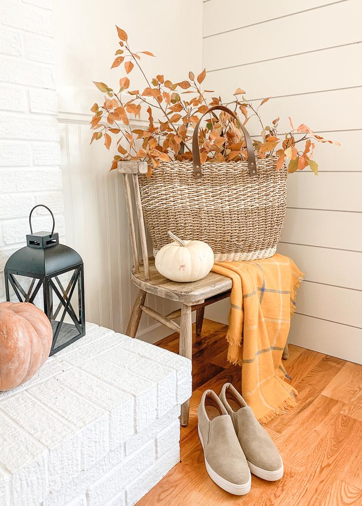 fall foliage in basket on chair