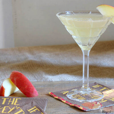 apple cider martini with cocktail shaker and napkins