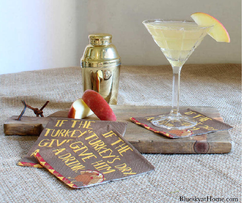 apple cider martini with cocktail shaker and napkins