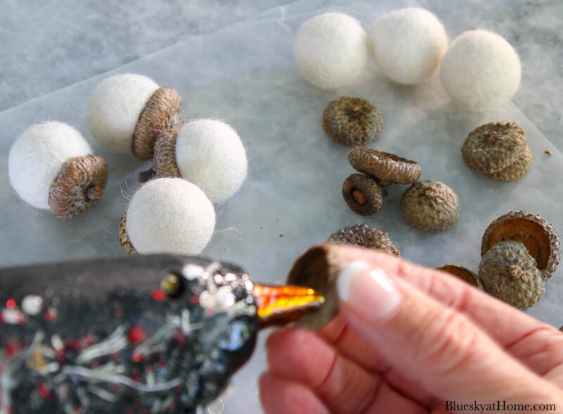 gluing acorn tops to white felt balls