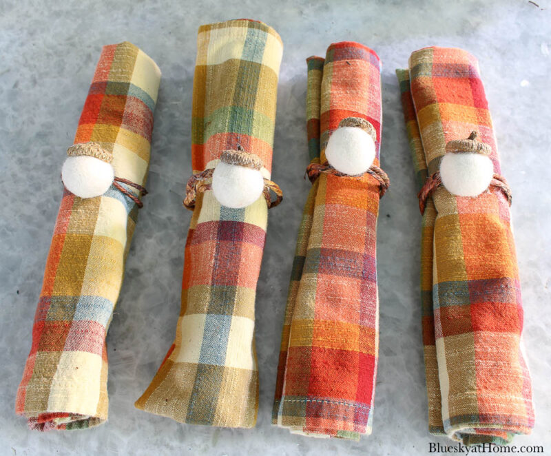 four fall plaid napkins with acorn napkin rings