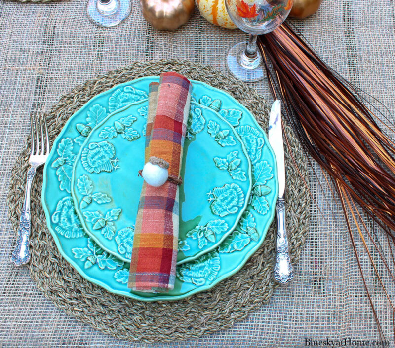 plaid napkin with acorn napkin ring on green Thanksgiving plate