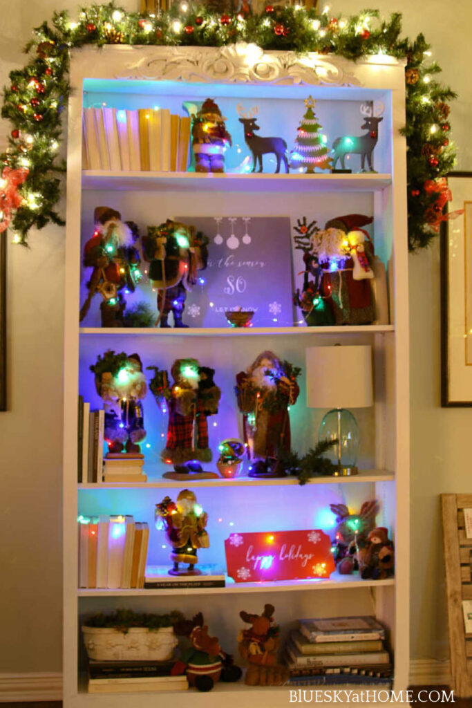 bookcase decorated with christmas garland and decorations