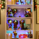 bookcase decorated with christmas garland and decorations