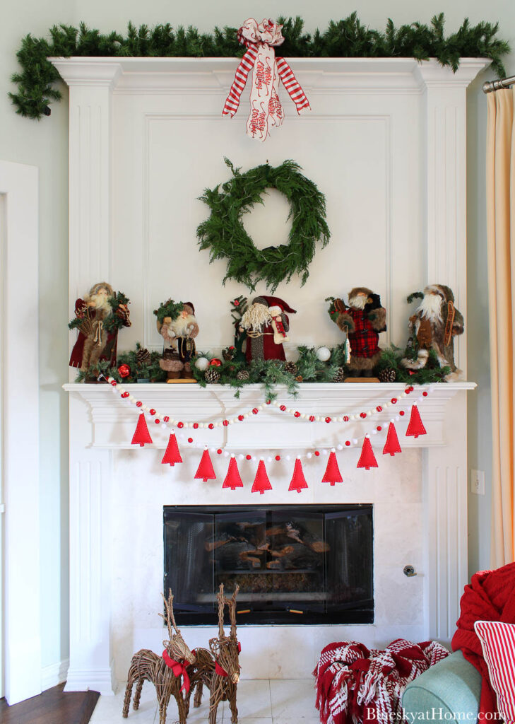 Santas on mantel with red and white garland