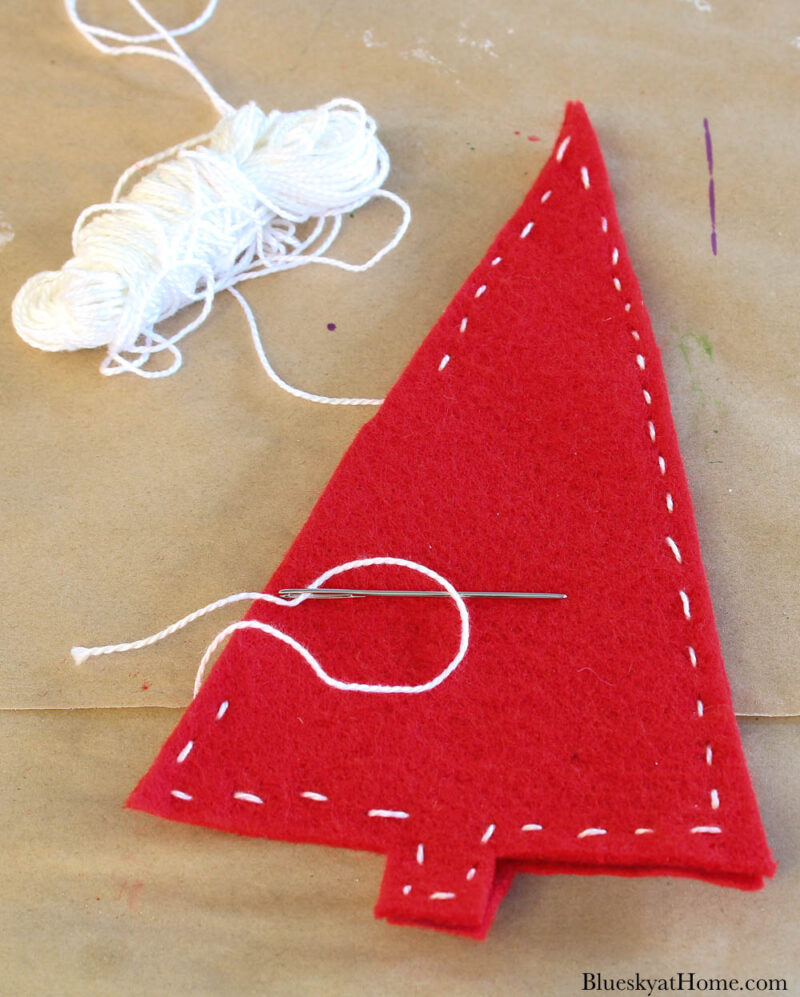 sewing red felt Christmas trees together