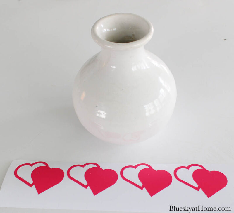 white bud vase with pink heart stickers