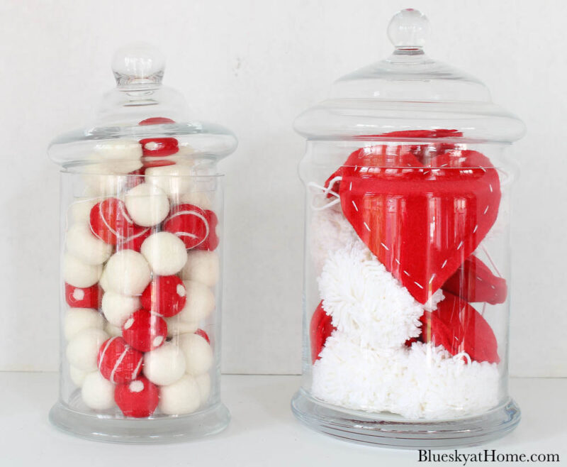 apothecary jars filled with red hearts and pom~poms