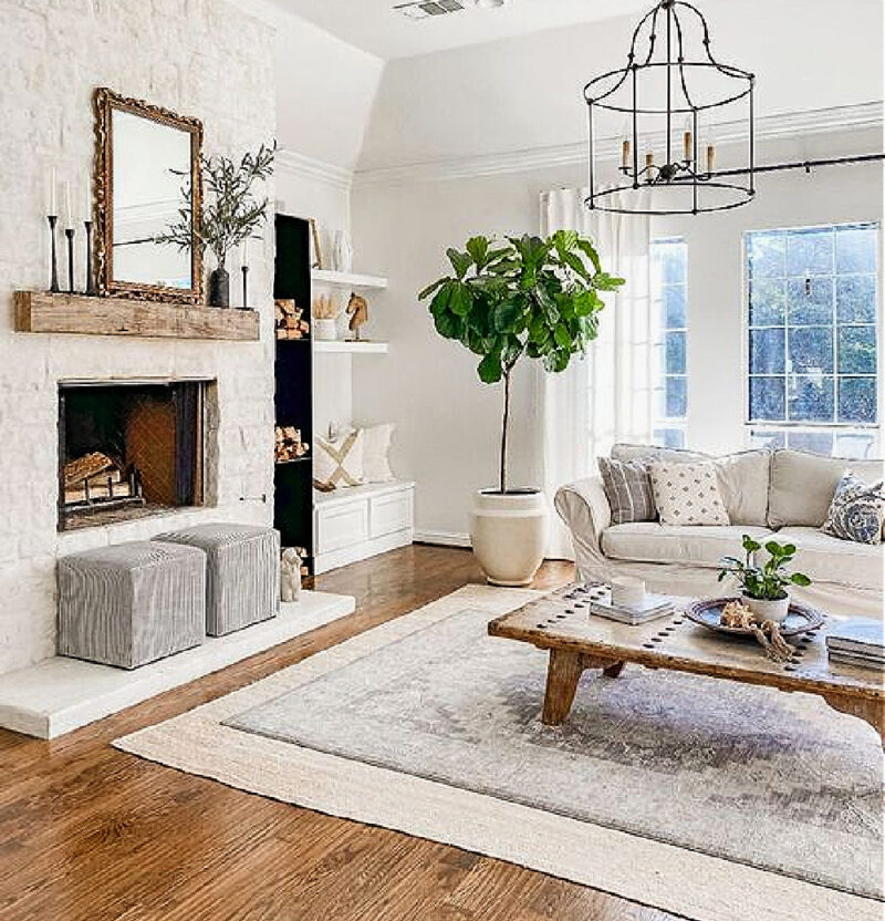 wood mantel in living room with shades of white