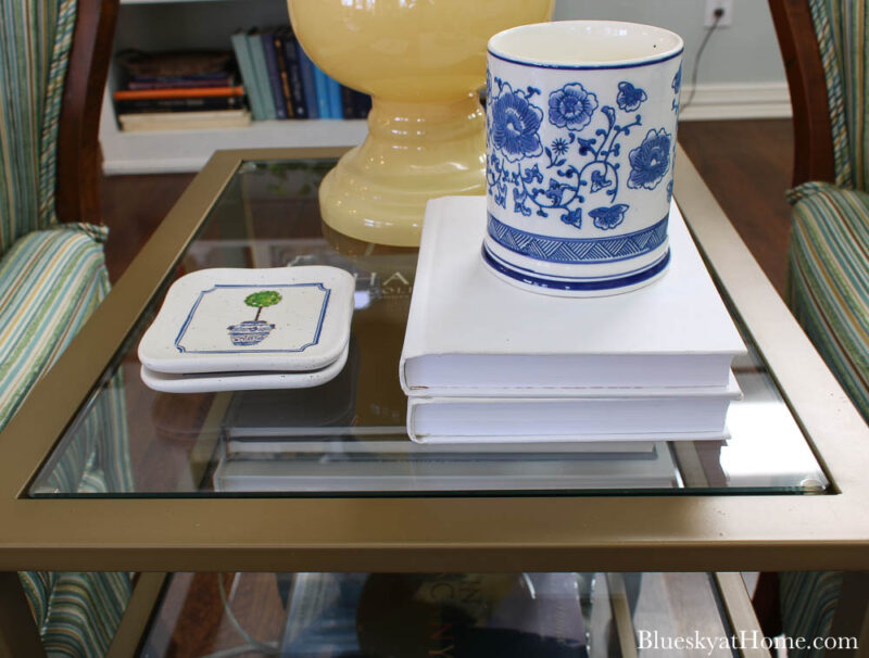 tile coasters on table with blue candle