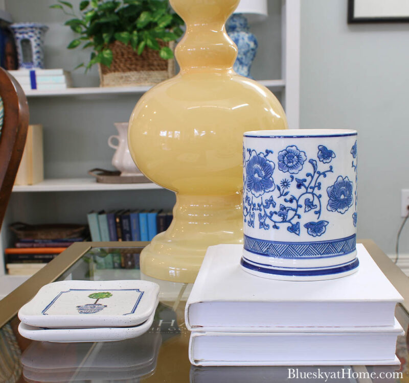 tile coasters on table with blue candle