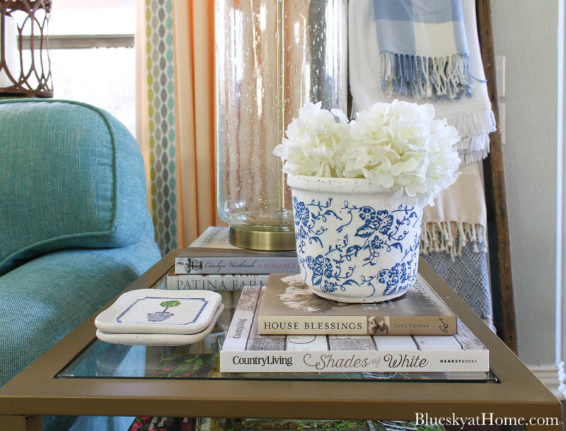 tile coasters on table with blue planter